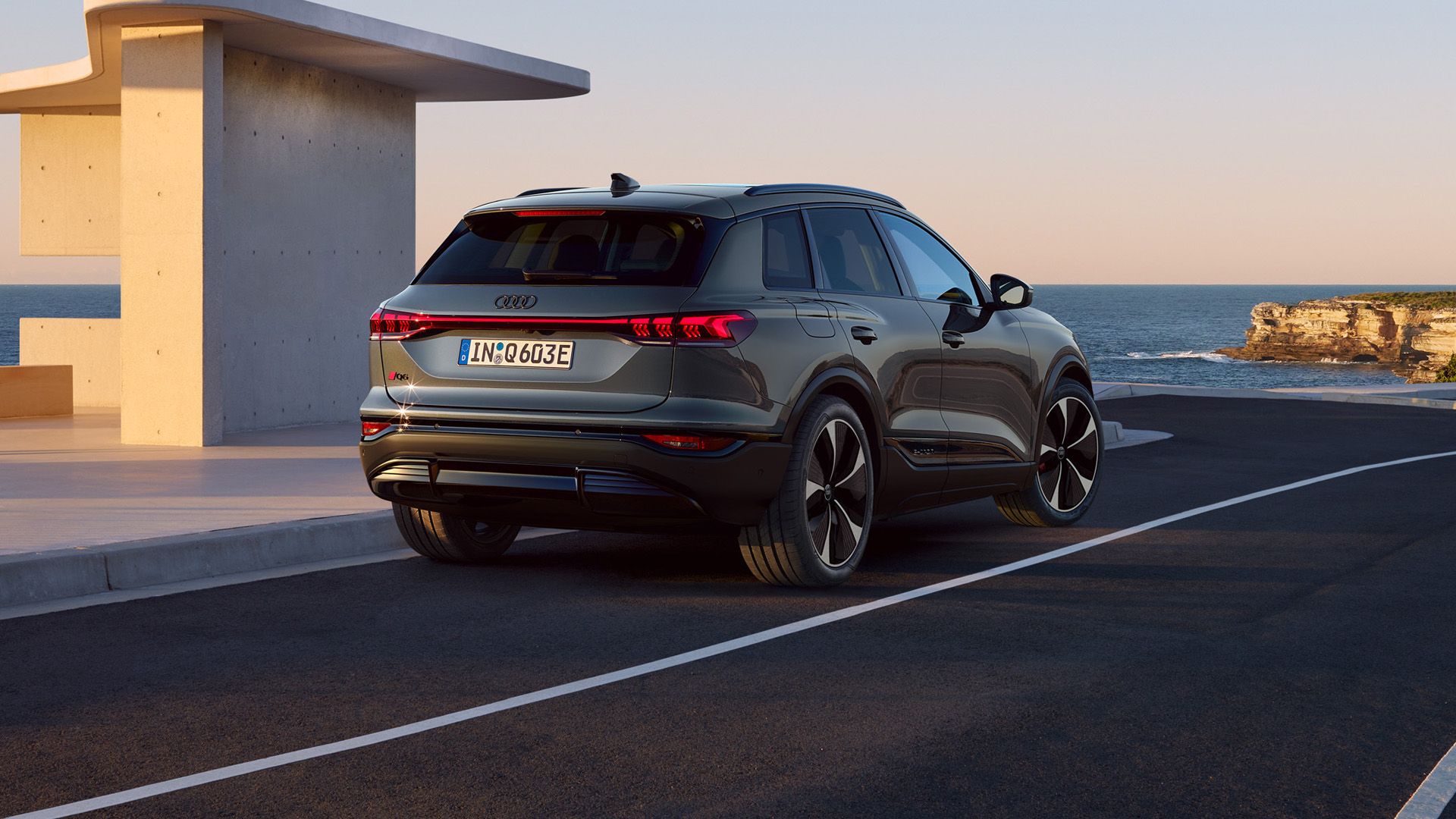 Rear view of the Audi Q6 e-tron at the charging station.