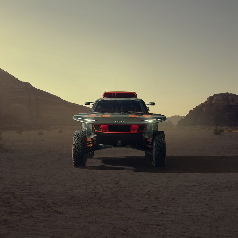 The Audi RS Q e-tron crosses a desert landscape.
