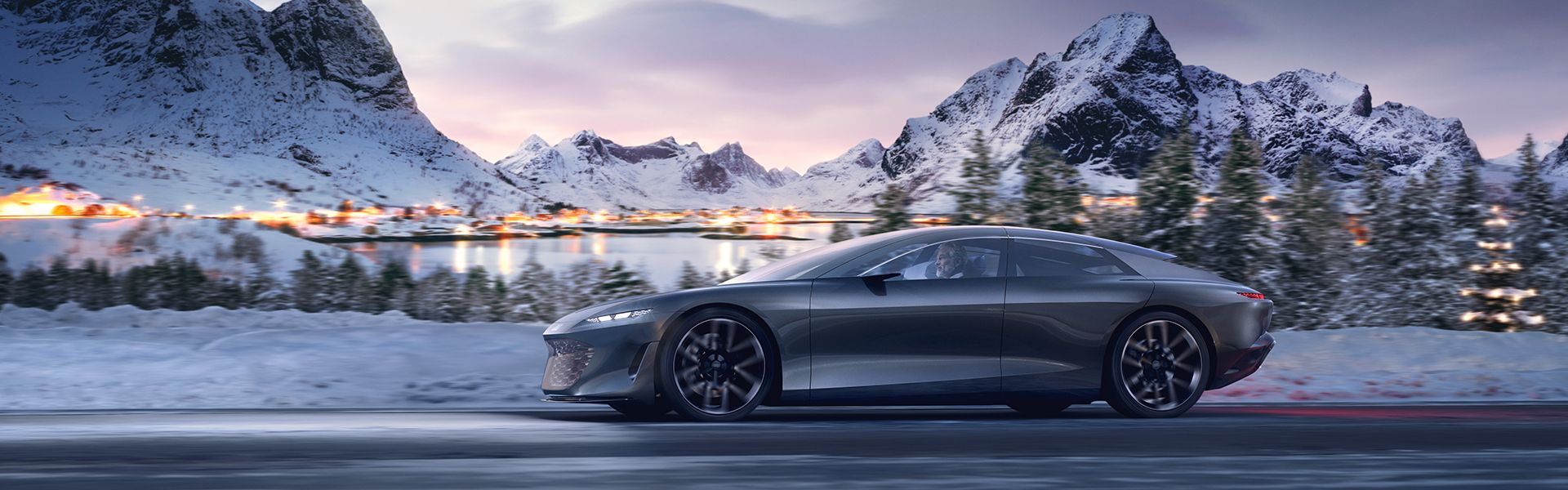 Der Audi grandsphere concept fährt auf der Straße vor einer verschneiten Landschaft mit Bergen.