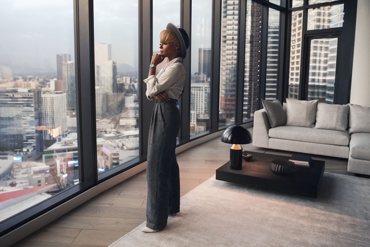 Janelle Monáe standing in an apartment with a view