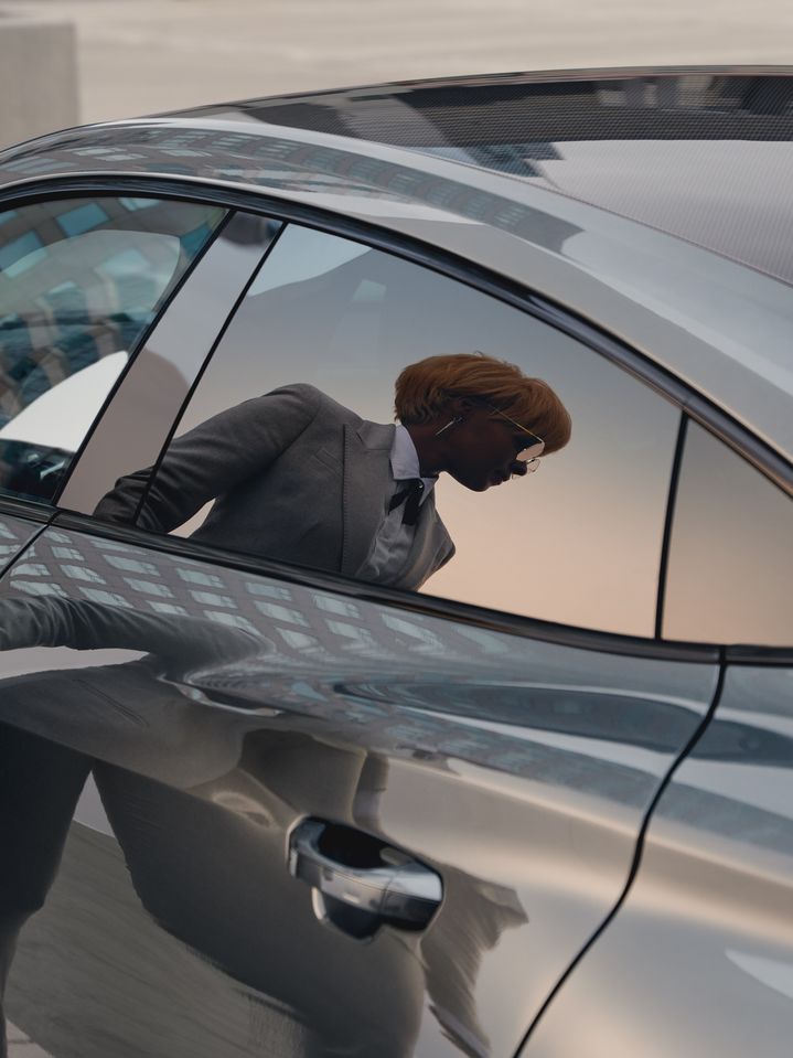Janelle Monáe is reflected in the rear side window of the Audi