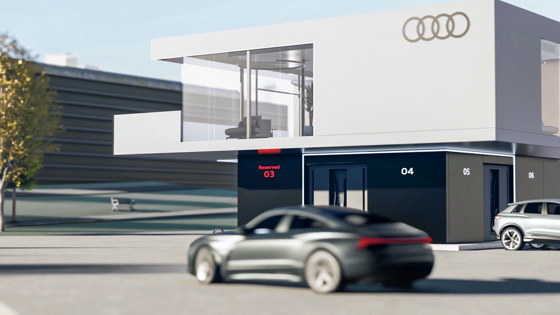 An Audi car stands in front of the Audi charging hub.