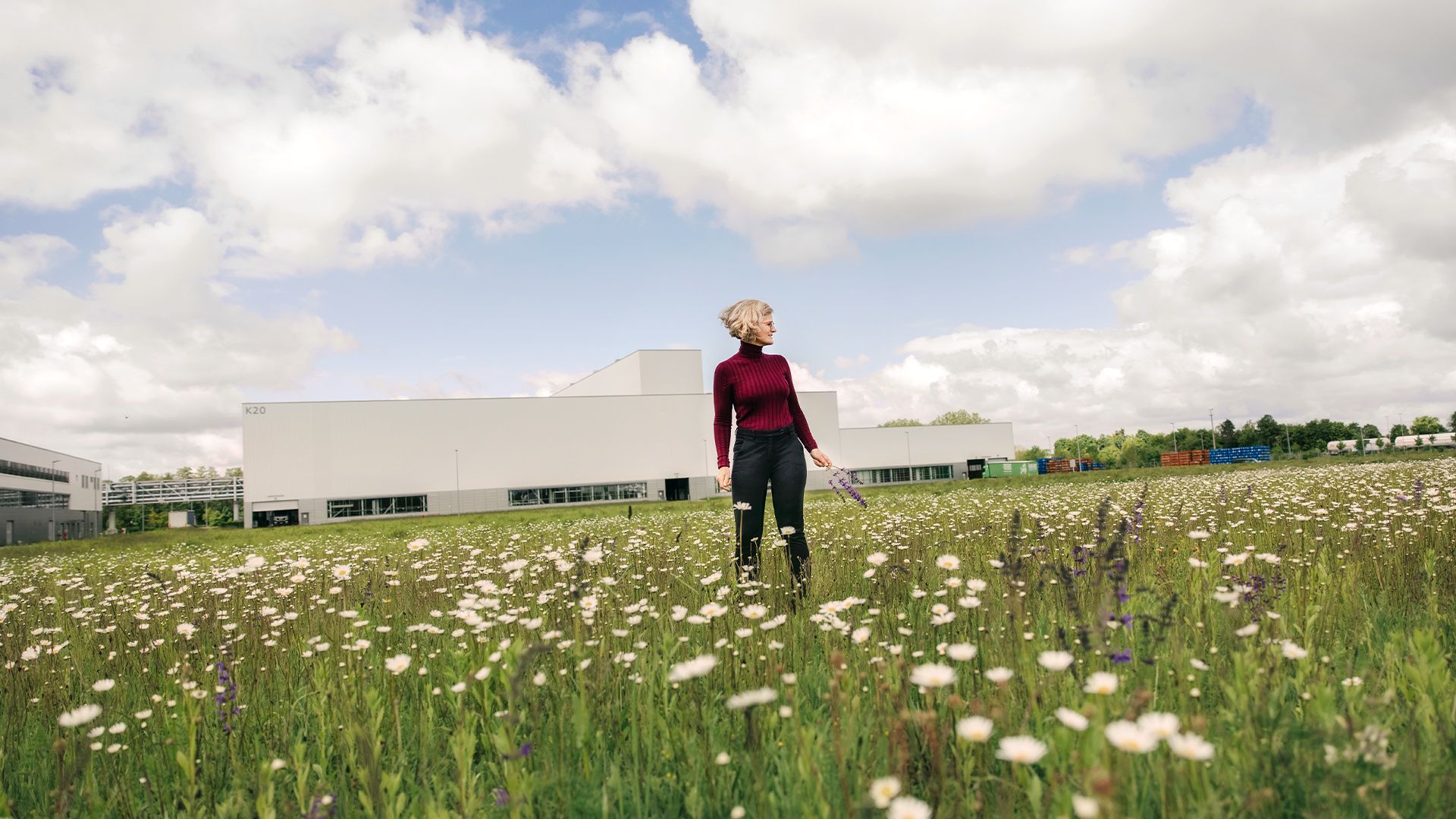 Dr. Antje, spokeswoman for environmental protection at Audi, standing in a meadow on the Audi production site in Münchsmünster. 