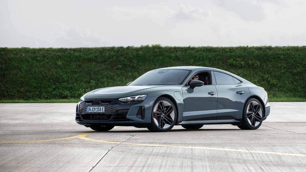 A full-length image of black the Audi RS e-tron GT with Ken Block sitting in it.