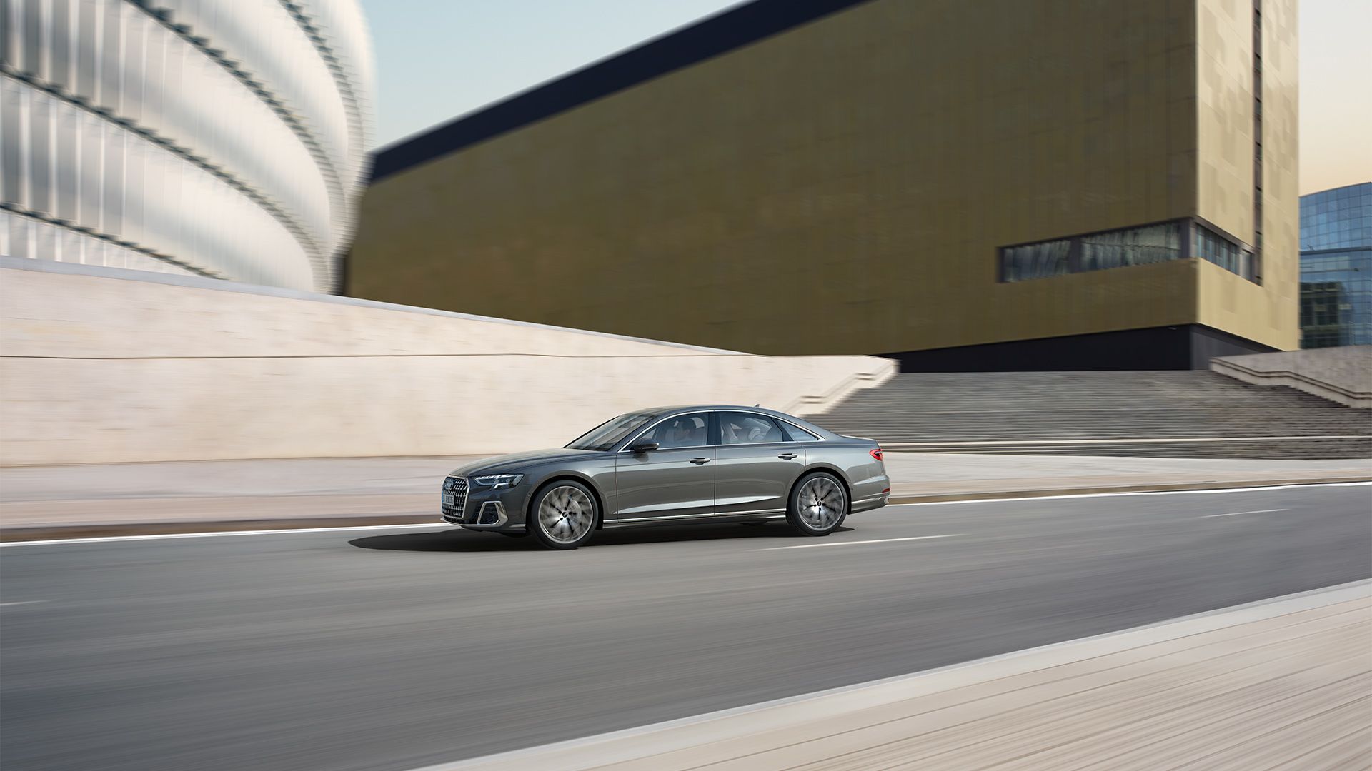An Audi A8 sedan seen from the side as it drives.