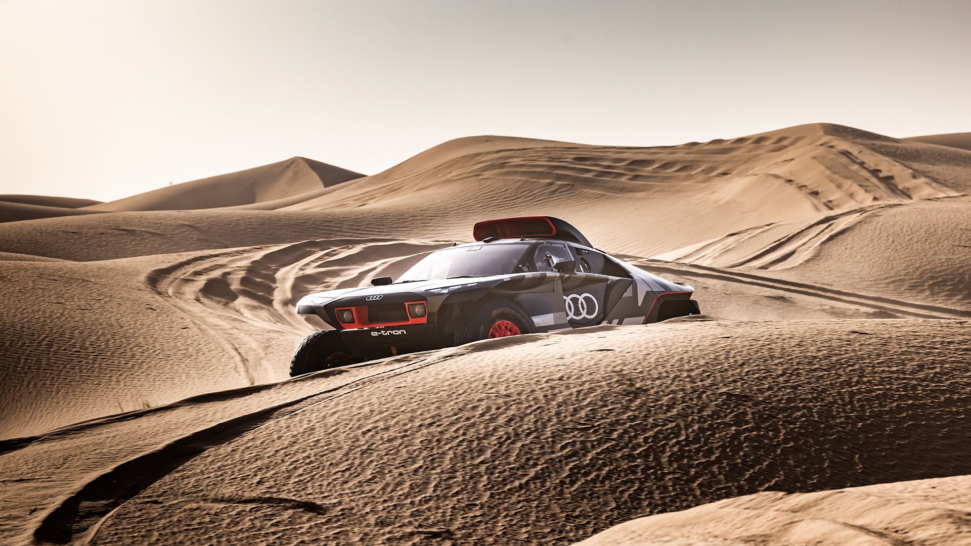 The Audi RS Q e-tron driving through the desert.