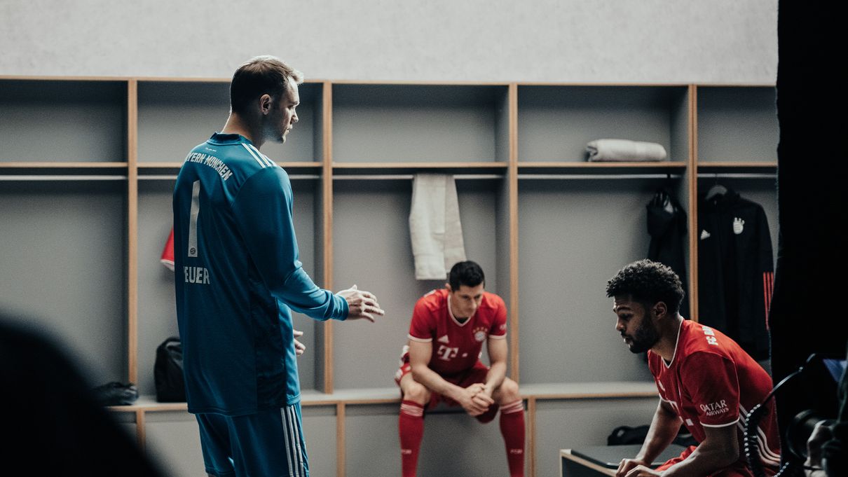 FC Bayern Munich captain Manuel Neuer talks to teammates Robert Lewandowski and Serge Gnabry.
