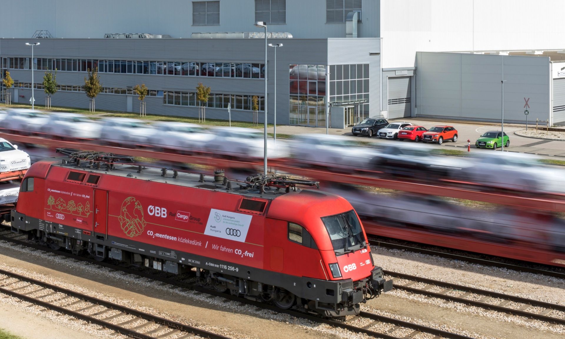 A freight train of the Austrian Federal Railways ÖBB in front of an Audi plant.