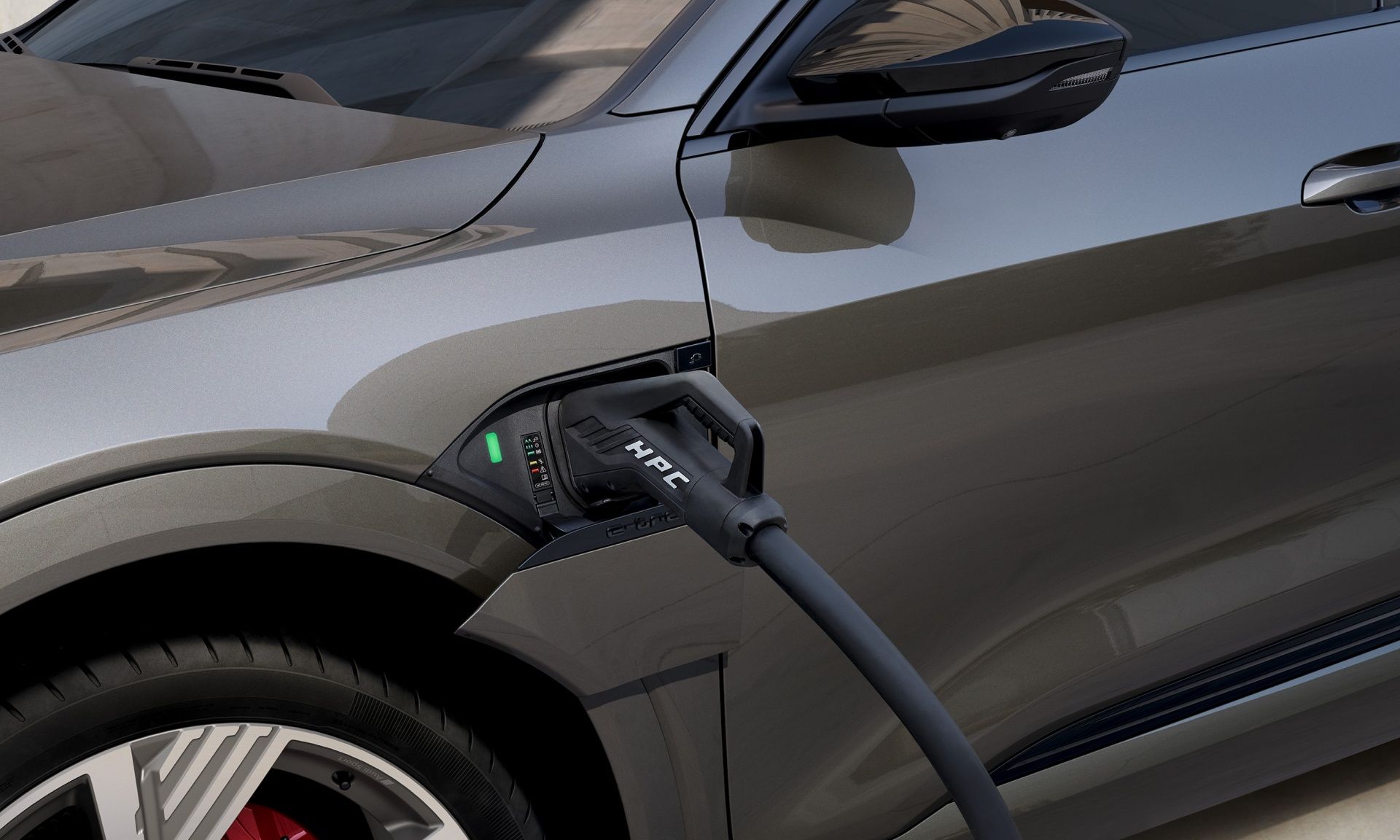 A high-power charging cable connected to the Audi Q8 e-tron.