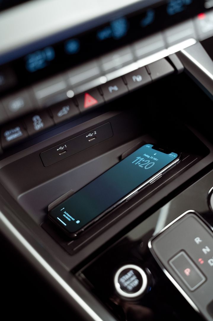 A smartphone in the dashboard compartment.