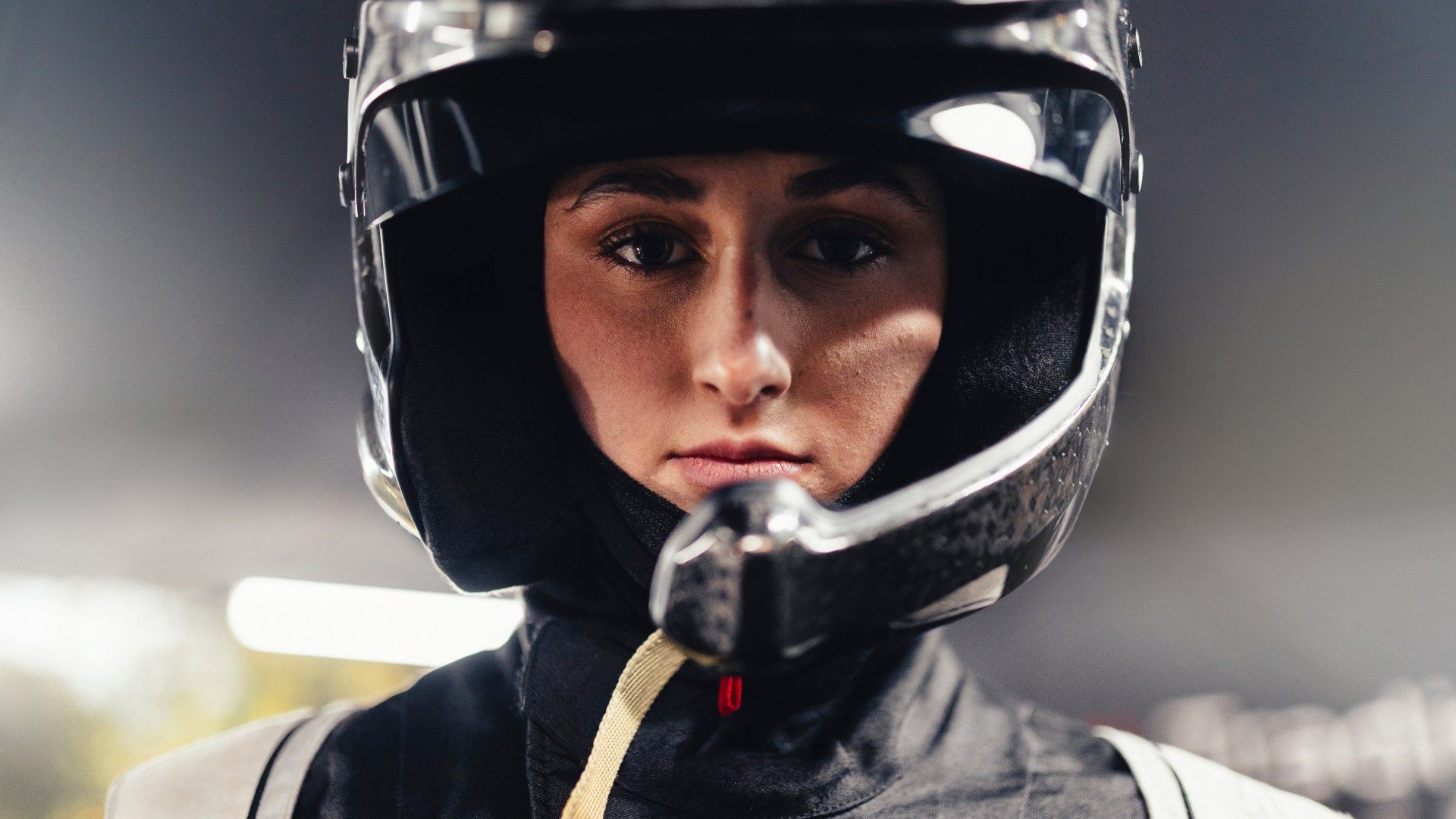 Close-up shot of Lia Block wearing a racing helmet.